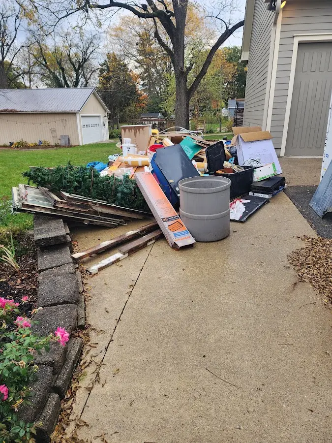 Dumpster being loaded with debris for Roofing Dumpster Rental in Oak Point